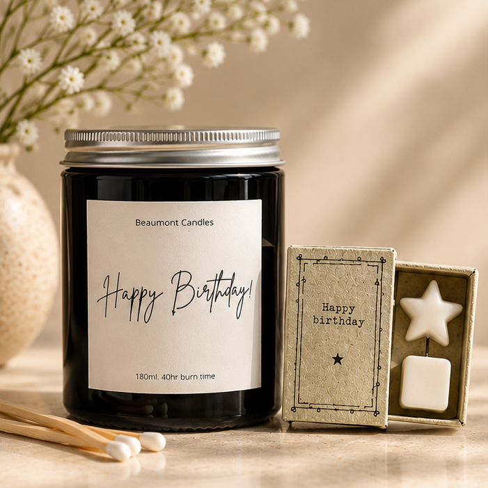 A 40hr burn soy wax candle with a silver lid and a white 'Happy Birthday!' label, and, a matchbox-style box containing a white star-shaped token, with the words happy birthday.