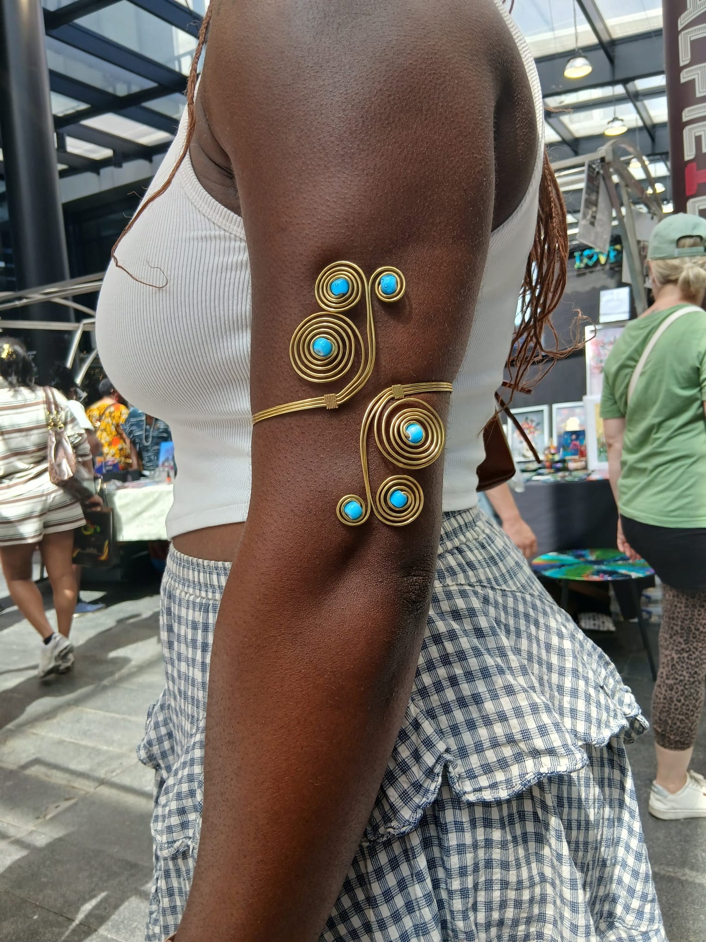  gold-toned spiral cuff bracelet with turquoise blue stone accents,